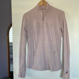 Lululemon define jacket in a very light pink color.
